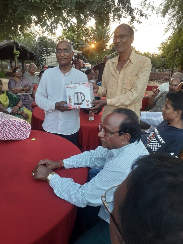 E. Ravinder Rao Garu receving prize as Lucky Man of the Day in get-together party held on 22-11-2023.